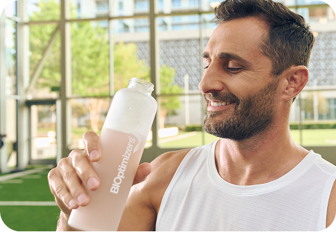 Athlete holding a BIOptimizers bottle with pink drink