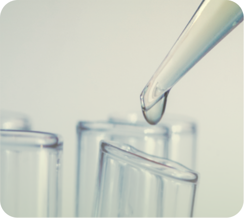 Laboratory pipette dropping liquid into test tubes
