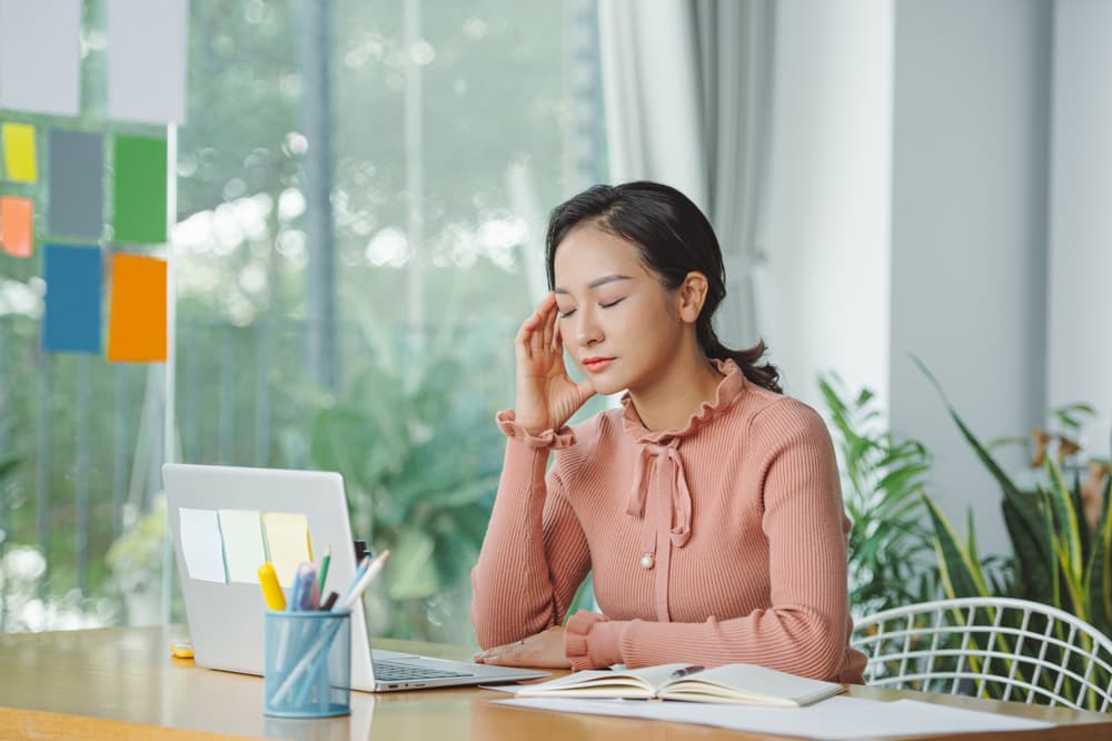 Woman stressed out working at a computer