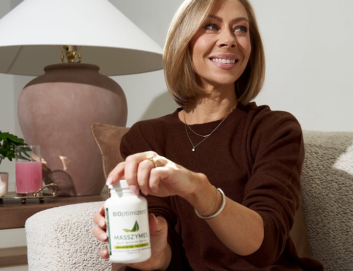 Woman with MassZymes bottle